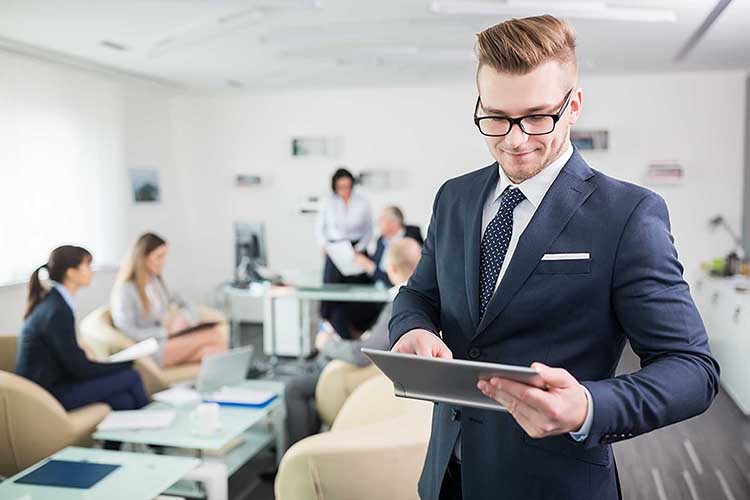 Guy in meeting holding tablet