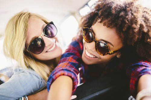 Best friends taking selfies in a car -learner driver insurance